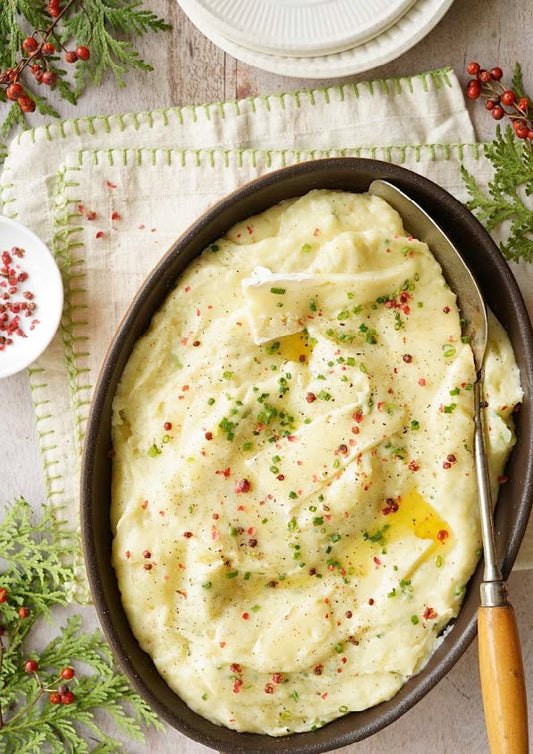 Purée de pommes de terre à la crème de brie, poivre rose et aromates